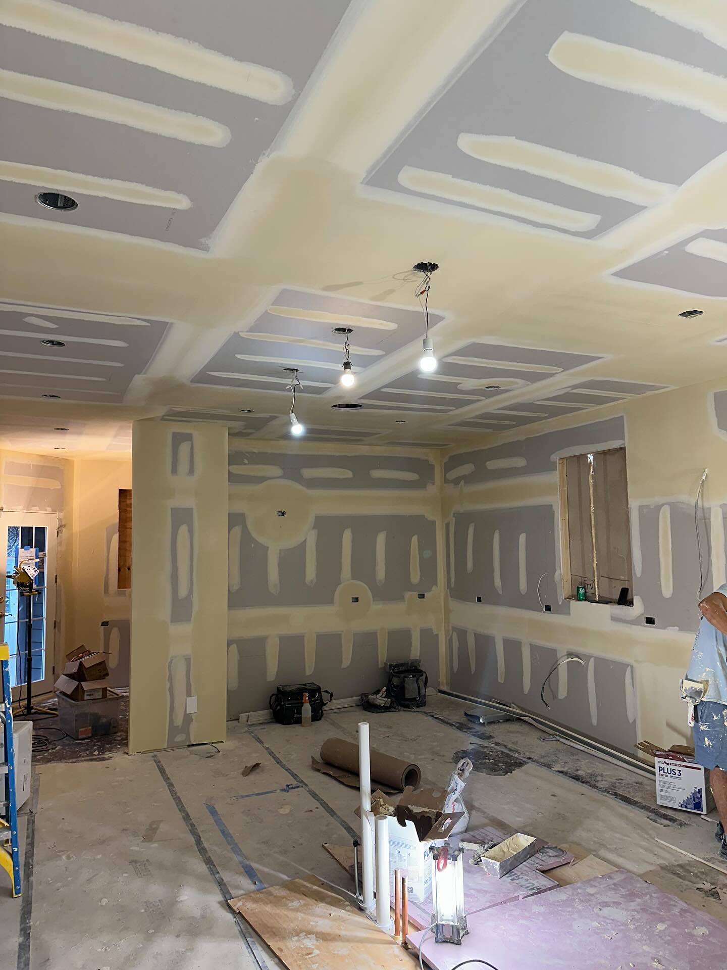 Drywall hung on walls and ceiling with first coat of mud, Glenview