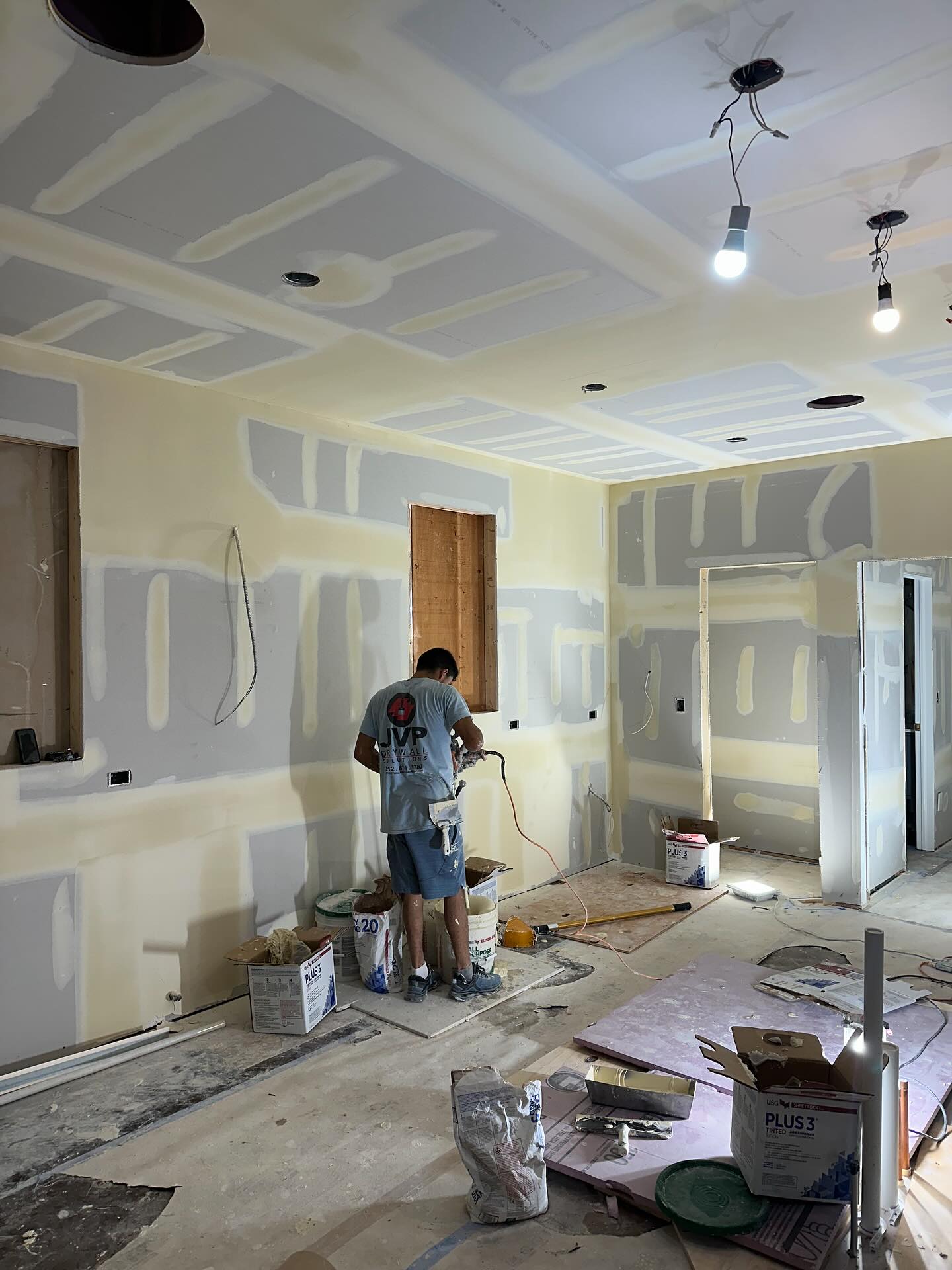 JVP crew member applying second coat with spray equipment, Glenview