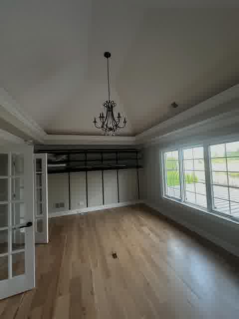 Vaulted ceiling bedroom with crystal chandelier, French doors, walk-in closet and lake view, Bloomingdale