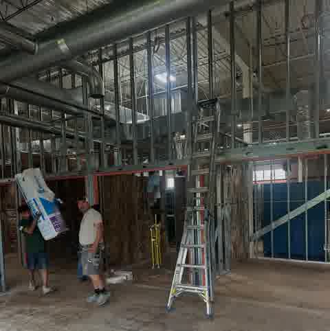 Commercial insulation work with steel studs and ductwork, JVP crew on site, Countryside